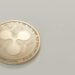 XRP coins with OKX logo, symbolizing RLUSD stablecoin launch on the exchange.