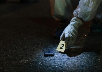 FBI agents gather evidence related to cryptocurrency scams during a major crackdown.