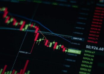 Stock market display showing a downward trend amid financial news and geopolitical tensions.