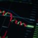 A fluctuating Bitcoin price chart with a downward trend highlighted.