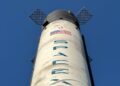 Bitget's logo alongside a Solana blockchain graphic and a SpaceX rocket launching.