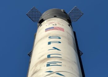 Bitget's logo alongside a Solana blockchain graphic and a SpaceX rocket launching.
