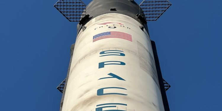 Bitget's logo alongside a Solana blockchain graphic and a SpaceX rocket launching.