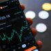 A Binance.US interface showing reduced trading fees and crypto charts.