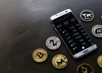 A smartphone displaying cryptocurrency transaction notifications with banking icons in the background.