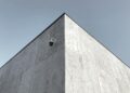 Coinbase building exterior with a digital asset custody security graphic overlay.
