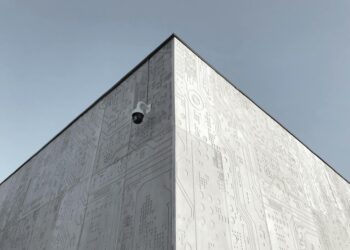 Coinbase building exterior with a digital asset custody security graphic overlay.
