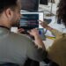 A diverse team collaborates at a computer, showcasing Dreamspace's no-code Web3 tool.