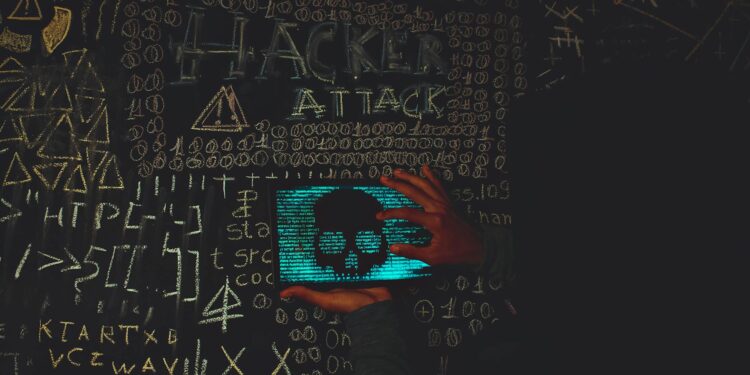 A hacker in a dark hoodie with cryptocurrency symbols and graphs in the background.