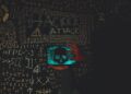 A hacker's silhouette with cryptocurrency symbols, highlighting cybersecurity threats.