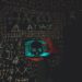 A hacker's silhouette with cryptocurrency symbols, highlighting cybersecurity threats.