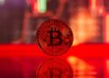 Bitcoin symbol with a downward trend line overlaid, oil barrels in background, reflecting market volatility.