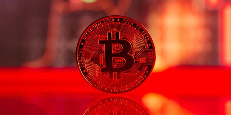 Bitcoin symbol with a downward trend line overlaid, oil barrels in background, reflecting market volatility.