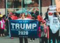 A bustling campaign event with supporters holding signs for the Ohio Senate race.