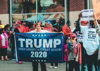 A bustling campaign event with supporters holding signs for the Ohio Senate race.