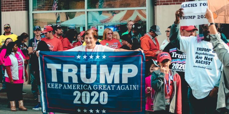 A bustling campaign event with supporters holding signs for the Ohio Senate race.