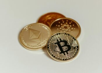Coins and cryptocurrency symbols on a digital background with a fine notice overlay.