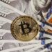 A stack of Bitcoin coins with financial graphs and dollar bills in the background.