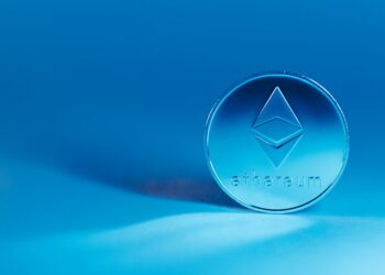 Ethereum logo against a backdrop of fluctuating cryptocurrency charts.