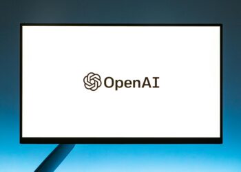 Coinbase logo displayed on a digital screen with AI graphics symbolizing enhanced security measures.