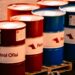 Oil barrels with rising price graphs, highlighting surging oil prices amid geopolitical tensions.