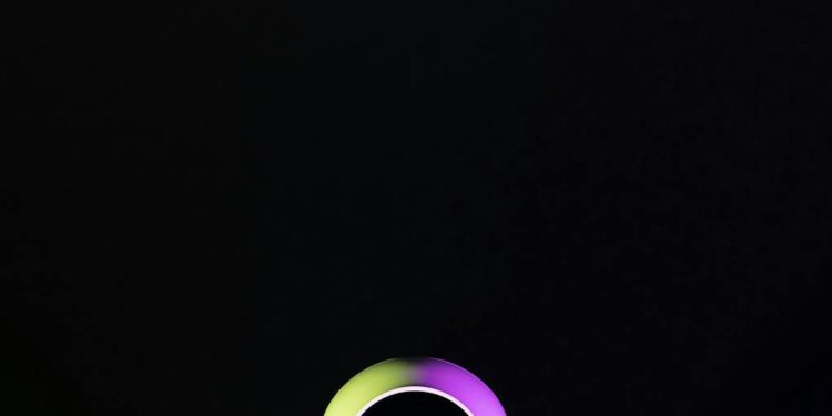 Xiaomi MiMo 2.5 Pro AI device featuring vision sensors against a colorful tech backdrop.