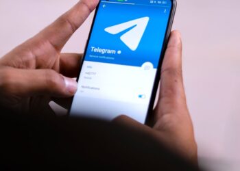 A smartphone screen displays the Agentic Wallet interface for managing Telegram AI transactions.