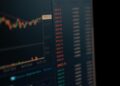 A digital representation of a Kraken logo overlaid on financial charts and cybersecurity symbols.