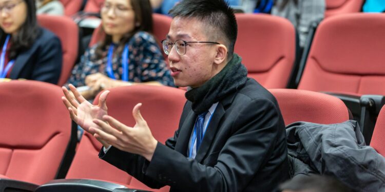 Justin Sun speaking at a conference, highlighting tensions in the crypto governance debate.