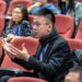 Justin Sun speaking at a conference, highlighting tensions in the crypto governance debate.