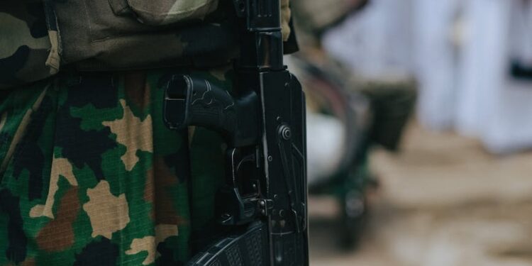 Soldiers on a military base, some carrying firearms, discussing new firearm policy.
