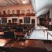 Legislators discussing AI surveillance warrant regulations in a government meeting room.