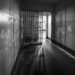 Crowded detention center with somber faces reflecting harsh conditions and reported violations.