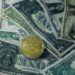 Stacks of cash and digital currency symbols reflecting financial negotiations with Iran.