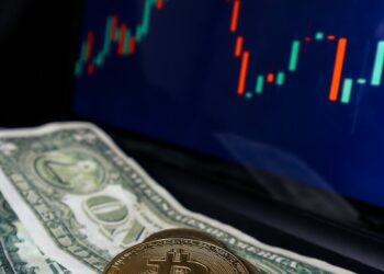 A Bitcoin logo surrounded by fluctuating graphs and dollar signs indicating market movement.