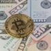 Bitcoin price graph trending upwards with an overlay of dollar bills and ETF symbols.