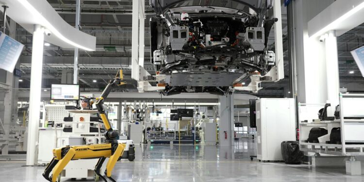 Industrial robots working collaboratively in a factory, enhanced by AI technology.