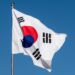 Digital representation of cryptocurrency with a North Korean flag and warning symbols.