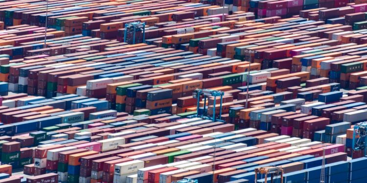 Freight containers at a shipping yard, symbolizing tokenization in real-world assets.