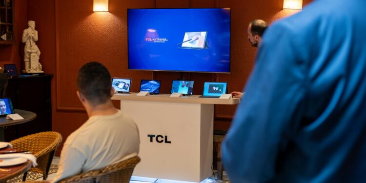 Engineers discussing chip designs at a tech conference, showcasing xAI's Terafab initiative.