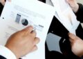Wall Street analysts reviewing financial charts related to SpaceX IPO and Grok AI subscription.