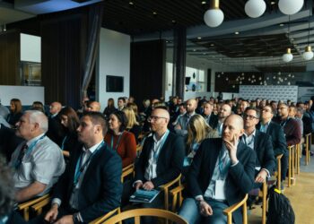 Conference attendees engage in discussions about Bitcoin's future and regulatory challenges.