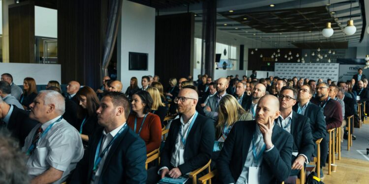 Conference attendees engage in discussions about Bitcoin's future and regulatory challenges.
