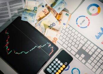 EDX Markets logo displayed with U.S. currency and regulatory documents on a desk.