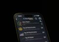User interface of a fraudulent Ledger Live app with warning signs and money graphics.