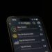 User interface of a fraudulent Ledger Live app with warning signs and money graphics.