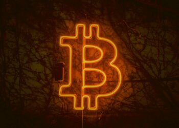 A digital representation of a Bitcoin symbol next to a warning sign indicating an error.