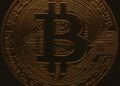 A digital illustration of a Bitcoin symbol bridging two blockchain networks for cross-chain transfers.