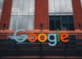 A Google logo superimposed on a Pentagon building, symbolizing AI partnership and controversy.