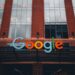 A Google logo superimposed on a Pentagon building, symbolizing AI partnership and controversy.